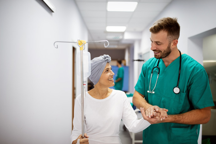 Mujer con quimioterapia acompañada de médico.